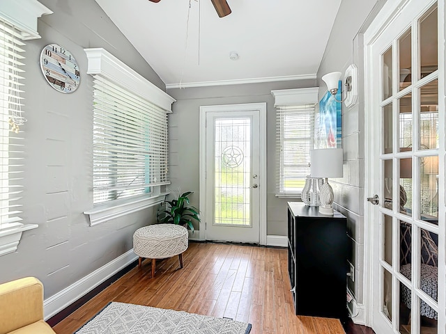 doorway to outside with hardwood / wood-style flooring, ceiling fan, and lofted ceiling