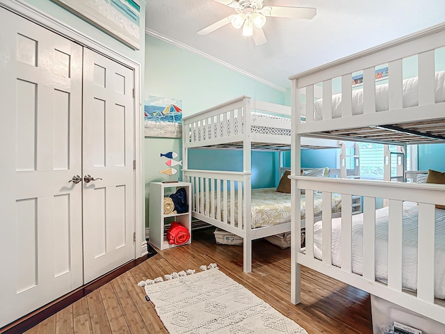 bedroom with crown molding, light hardwood / wood-style flooring, and ceiling fan