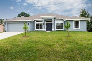 ranch-style house featuring a front yard and a garage