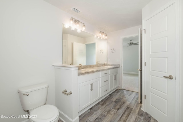 bathroom with ceiling fan, hardwood / wood-style floors, toilet, and vanity