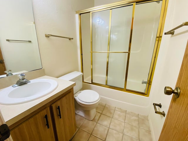 full bathroom with toilet, tile patterned flooring, enclosed tub / shower combo, and vanity