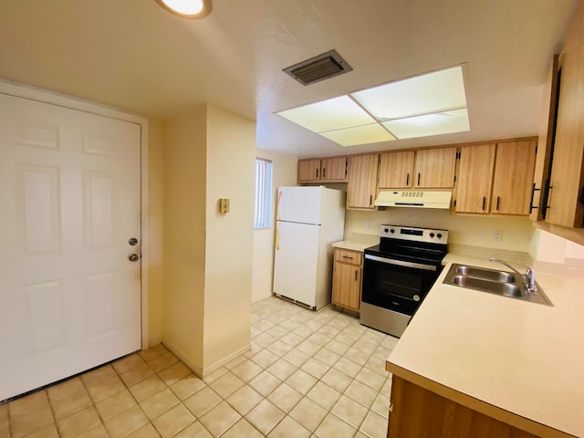 kitchen with stainless steel electric stove, white refrigerator, light tile patterned flooring, and sink