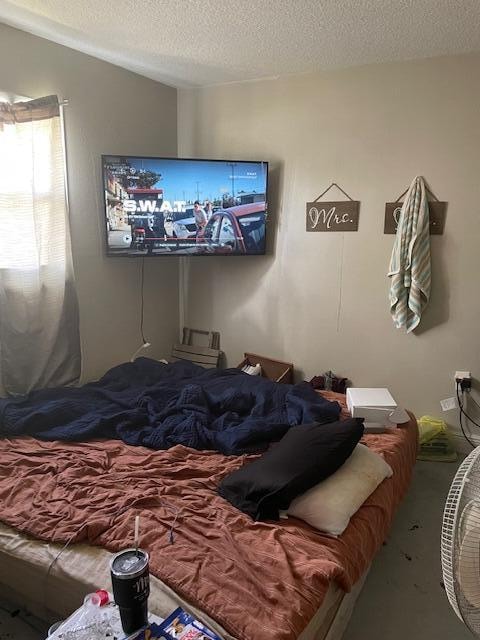 carpeted bedroom with a textured ceiling