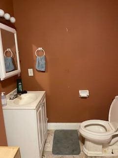 bathroom with vanity, tile patterned flooring, and toilet