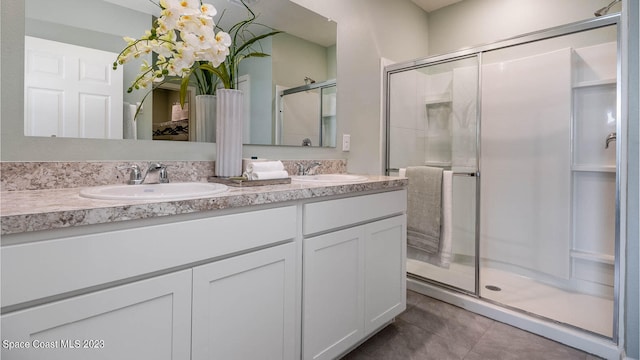 bathroom with a shower with shower door and vanity