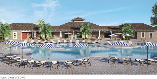 view of swimming pool with an outbuilding and a patio