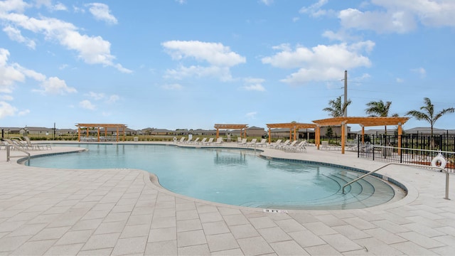 view of pool with a pergola and a patio