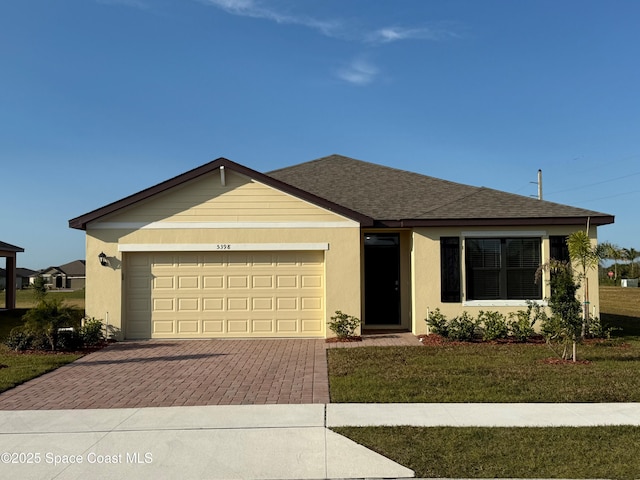 single story home with a front yard and a garage