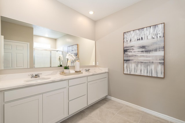 bathroom featuring an enclosed shower, vanity, and tile patterned floors