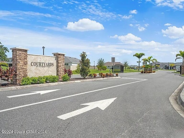 view of road with street lighting, a residential view, curbs, and sidewalks