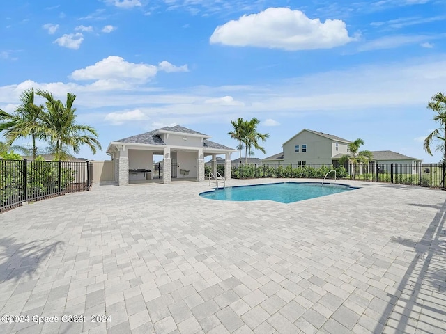 view of pool featuring a patio area, fence, and a fenced in pool