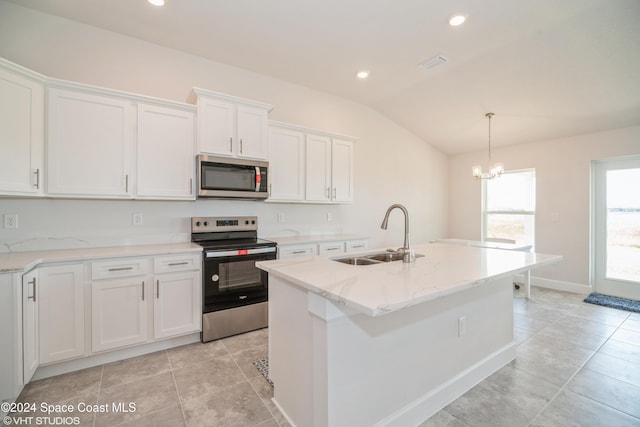 kitchen with appliances with stainless steel finishes, sink, white cabinetry, vaulted ceiling, and a center island with sink