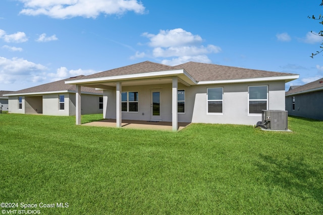 2283 Middlebury Dr SE, Palm Bay, FL 32909 - back of property featuring a yard, cooling unit, a patio, and a shingled roof
