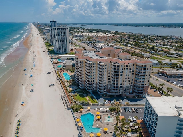 drone / aerial view featuring a view of the beach, a view of city, and a water view