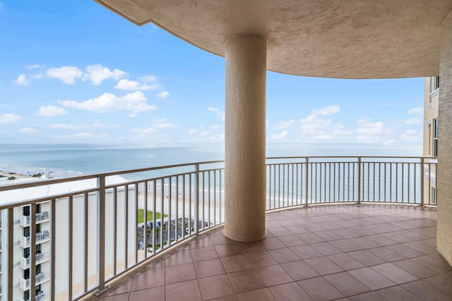 balcony with a view of the beach and a water view