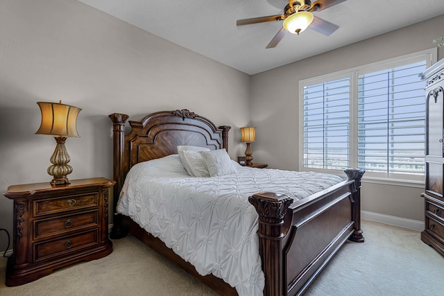 bedroom with baseboards, light colored carpet, and ceiling fan