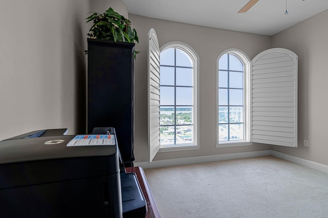 entryway with baseboards, carpet floors, and ceiling fan