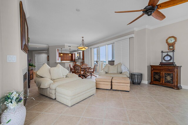 living room featuring light tile patterned floors, baseboards, ceiling fan, and crown molding