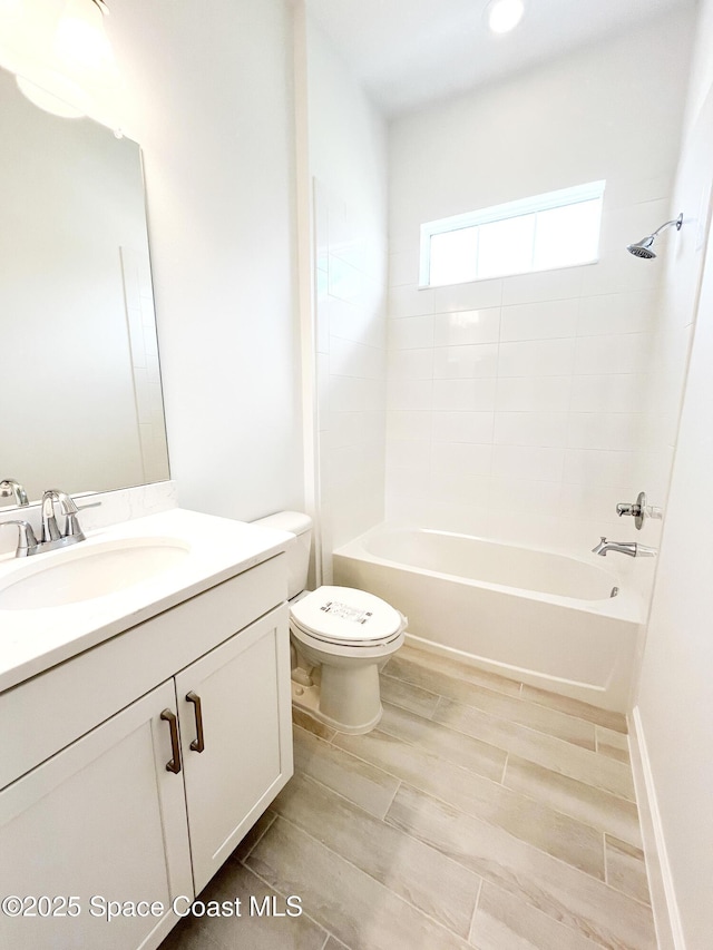 full bathroom featuring shower / bathtub combination, vanity, and toilet