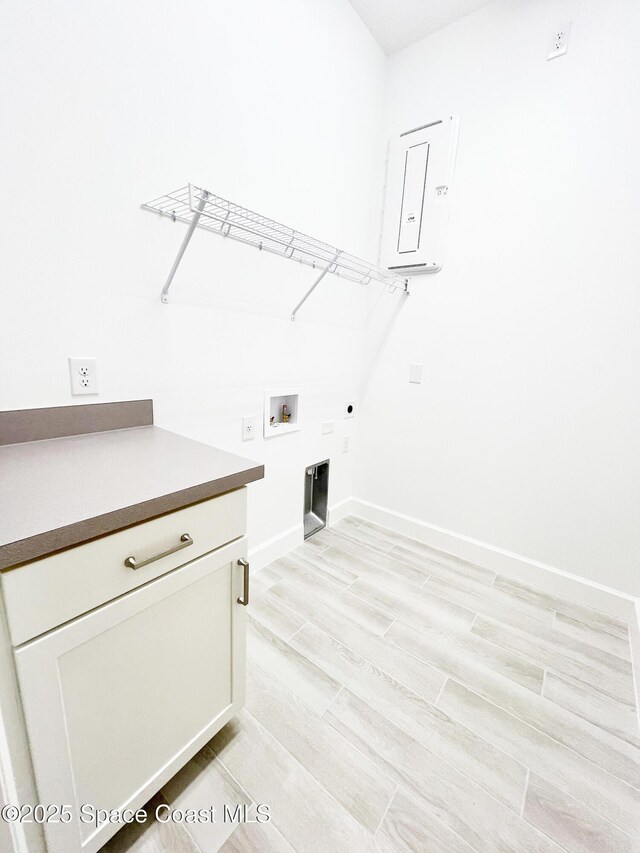 laundry area with light wood-style flooring, hookup for a washing machine, electric dryer hookup, and baseboards