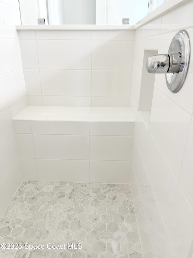 full bath featuring a tile shower