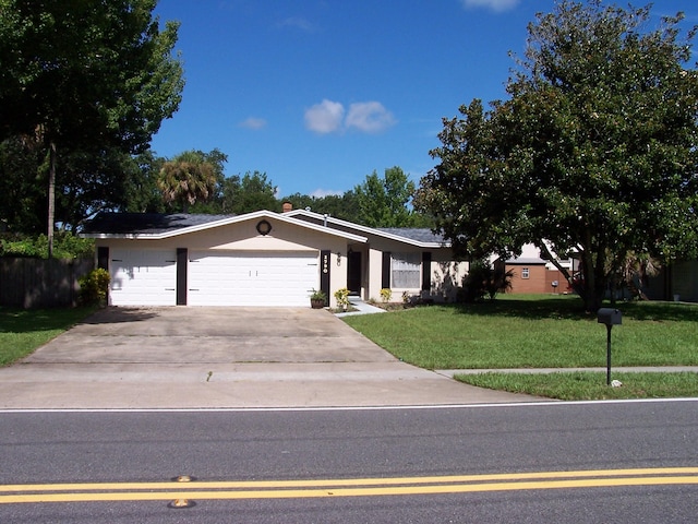 ranch-style home featuring a garage and a front yard