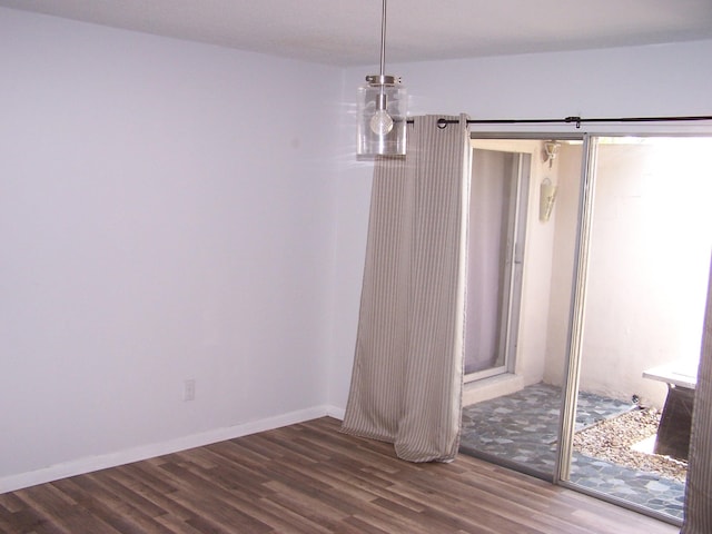 empty room with wood finished floors and baseboards