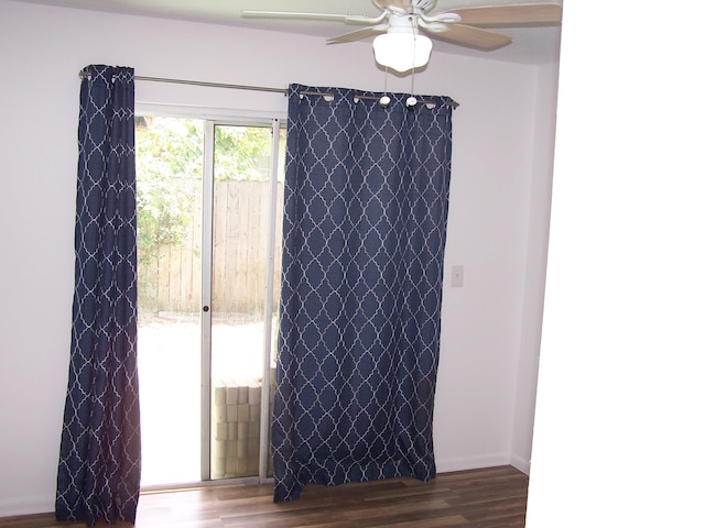 unfurnished room featuring a ceiling fan and wood finished floors