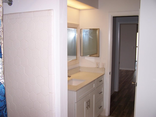 full bathroom featuring curtained shower, vanity, and wood finished floors