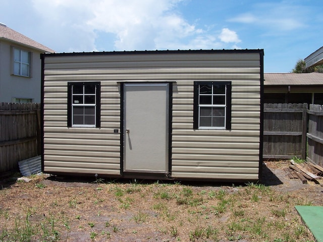 view of outdoor structure with a fenced backyard and an outdoor structure