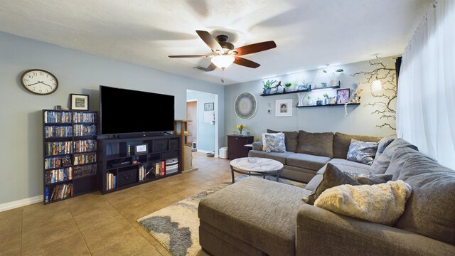 living room featuring light tile patterned floors and ceiling fan