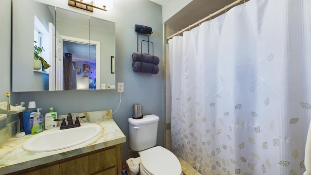 bathroom featuring vanity, toilet, and a shower with shower curtain