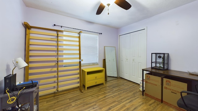 office with dark wood-type flooring and ceiling fan