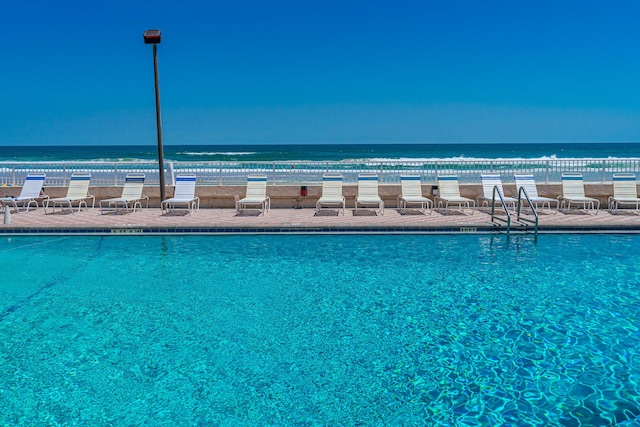 view of pool featuring a water view