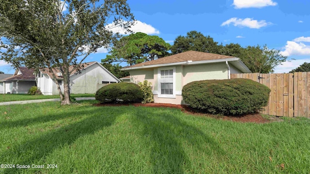 view of side of property featuring a yard