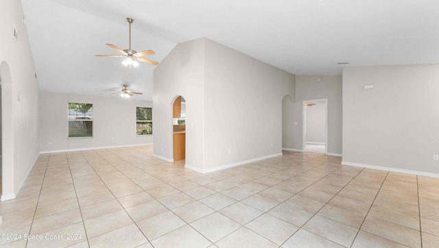 tiled spare room featuring ceiling fan and high vaulted ceiling