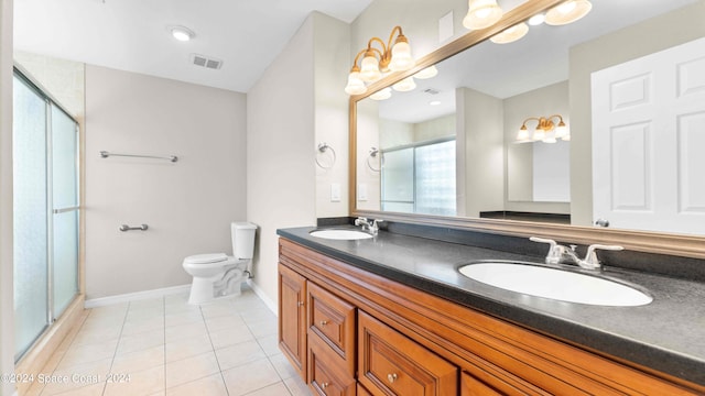 bathroom with walk in shower, vanity, tile patterned flooring, and toilet