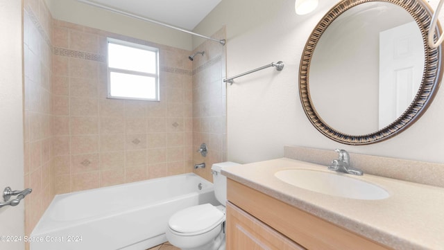 full bathroom with tiled shower / bath combo, vanity, and toilet