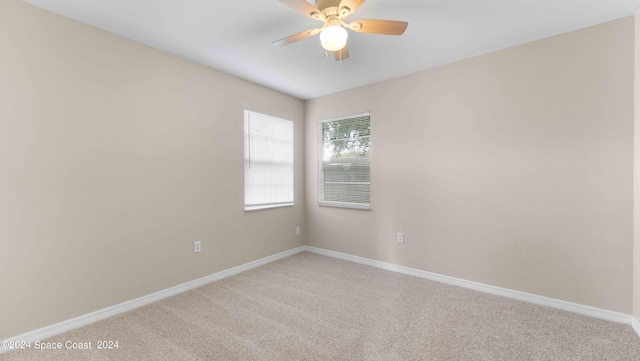 spare room featuring ceiling fan and carpet floors