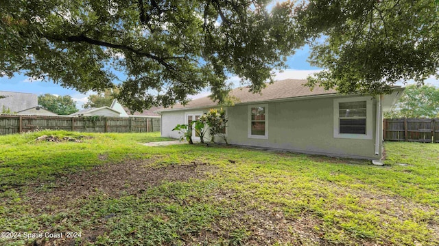 rear view of property with a yard