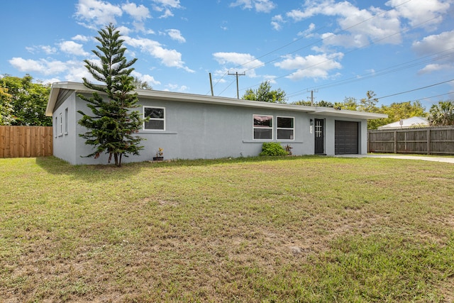 rear view of house featuring a garage and a yard