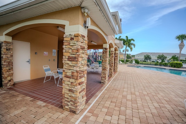 view of patio featuring a community pool