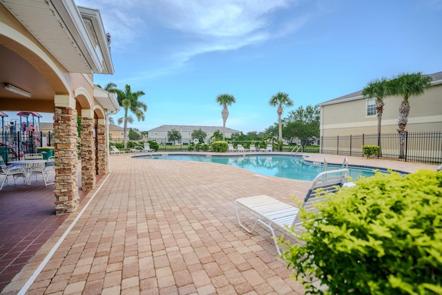 view of swimming pool with a patio area