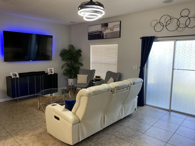 living room featuring light tile patterned flooring and a chandelier