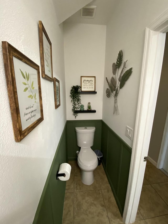 bathroom with toilet and tile patterned floors