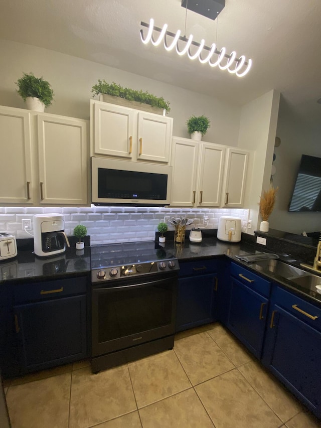 kitchen featuring light tile patterned floors, white cabinetry, range with electric stovetop, and blue cabinets