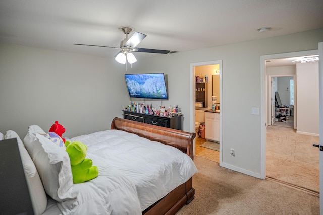 carpeted bedroom with ceiling fan and ensuite bath