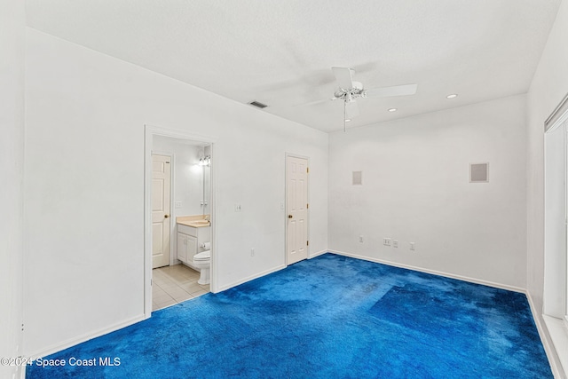 unfurnished bedroom featuring carpet, connected bathroom, and ceiling fan