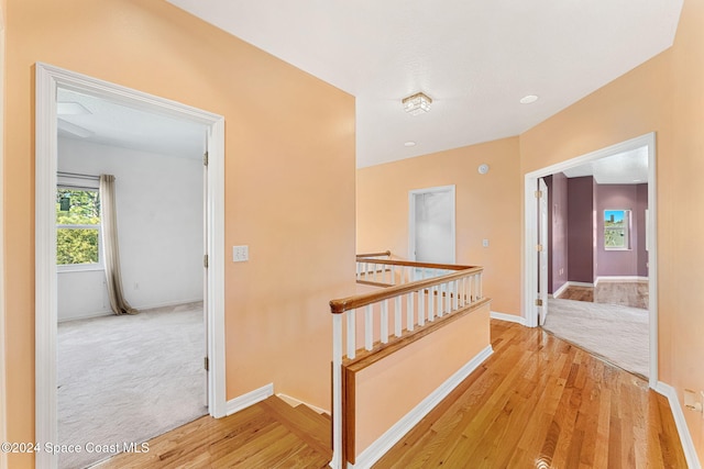 corridor with light hardwood / wood-style flooring