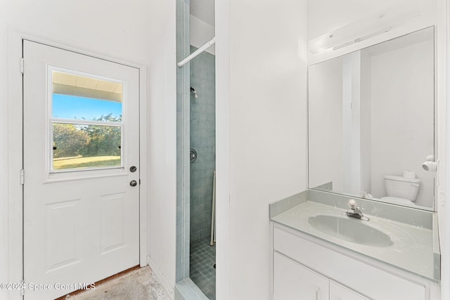 bathroom with vanity, toilet, and walk in shower